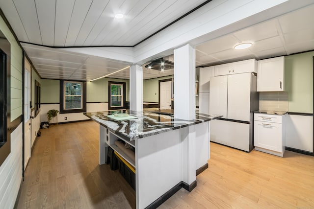 486 Barlow St, Bristol, CT 06010 - kitchen featuring freestanding refrigerator, white cabinets, light wood-style floors, and a kitchen island