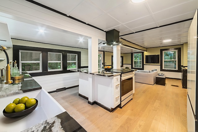 486 Barlow St, Bristol, CT 06010 - kitchen with electric range, light wood-style floors, white cabinetry, open floor plan, and dark stone counters