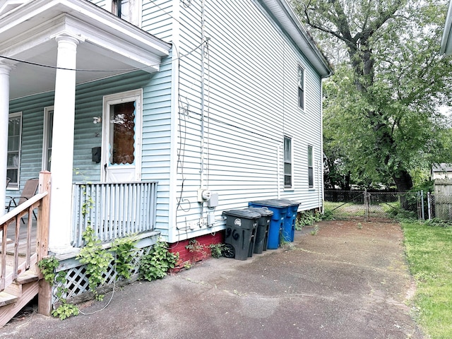 26 Lamberton St, New Haven, CT 06519 - view of side of home featuring covered porch and a gate