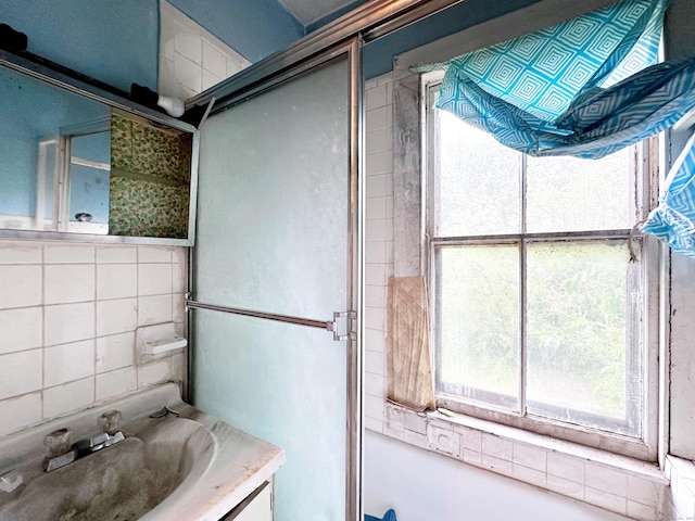 26 Lamberton St, New Haven, CT 06519 - full bath with healthy amount of natural light, vanity, tile walls, and decorative backsplash