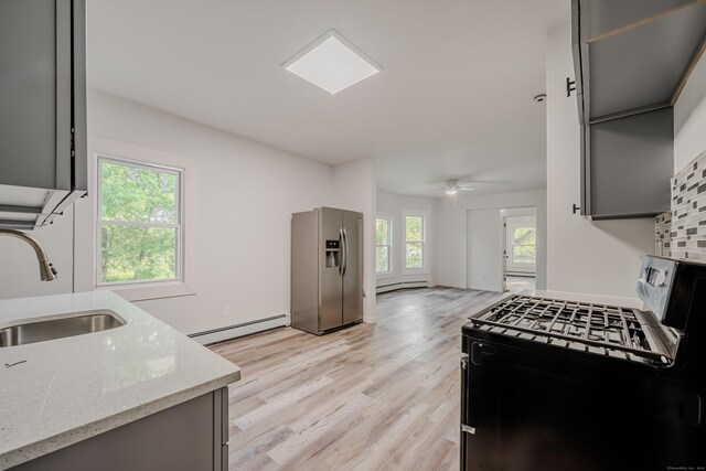 156 Waterville St, Waterbury, CT 06710 - kitchen featuring range with gas cooktop, stainless steel fridge, baseboard heating, light stone counters, and ceiling fan