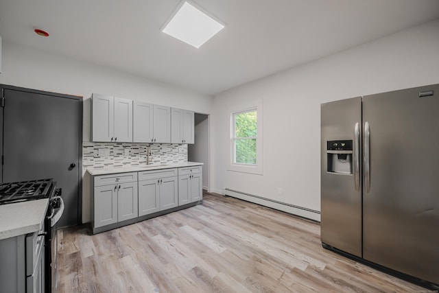 156 Waterville St, Waterbury, CT 06710 - kitchen featuring appliances with stainless steel finishes, a baseboard heating unit, light countertops, and light wood finished floors