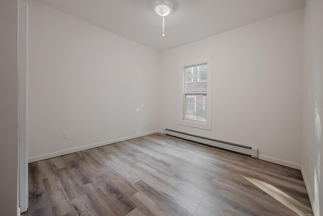 156 Waterville St, Waterbury, CT 06710 - unfurnished room with a baseboard heating unit, wood finished floors, and a ceiling fan