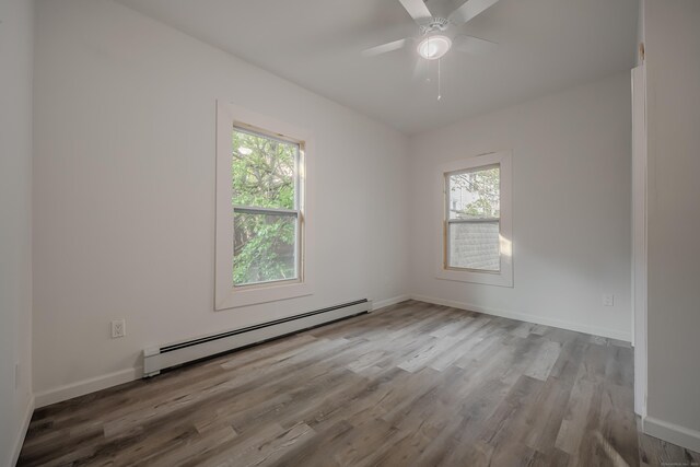 156 Waterville St, Waterbury, CT 06710 - spare room with a baseboard heating unit, healthy amount of natural light, wood finished floors, and a ceiling fan