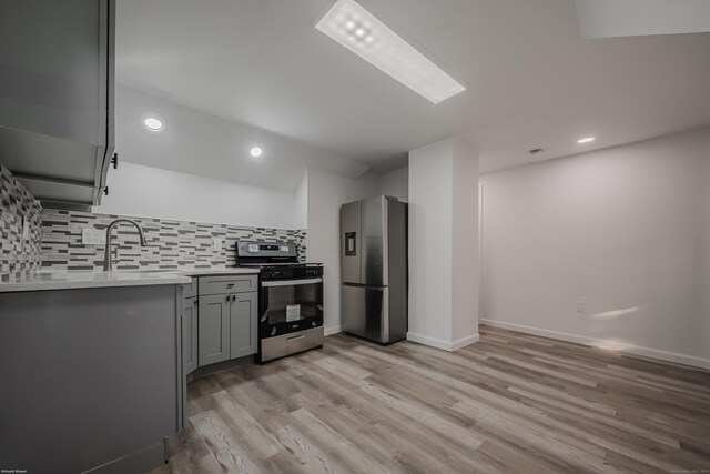 156 Waterville St, Waterbury, CT 06710 - kitchen featuring stainless steel appliances, gray cabinetry, tasteful backsplash, light countertops, and light wood-type flooring