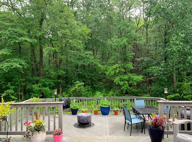 127 Skunk Misery Rd, Haddam, CT 06441 - deck with outdoor dining space, a grill, and a wooded view