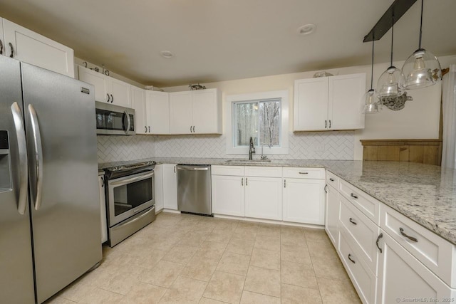 127 Skunk Misery Rd, Haddam, CT 06441 - kitchen featuring stainless steel appliances, decorative backsplash, white cabinets, light stone counters, and hanging light fixtures