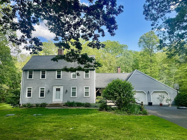 127 Skunk Misery Rd, Haddam, CT 06441 - colonial home featuring a chimney, a front lawn, a garage, and asphalt driveway