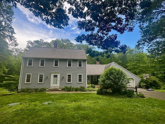 127 Skunk Misery Rd, Haddam, CT 06441 - colonial inspired home featuring a chimney, a front yard, and asphalt driveway
