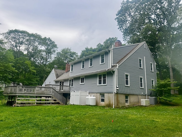 127 Skunk Misery Rd, Haddam, CT 06441 - back of house with a chimney, a deck, a lawn, and view of scattered trees
