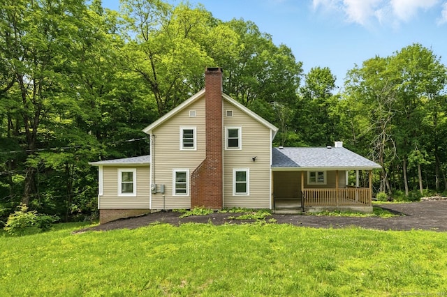 971 New Litchfield St, Torrington, CT 06790 - back of property featuring covered porch, a lawn, a chimney, and roof with shingles