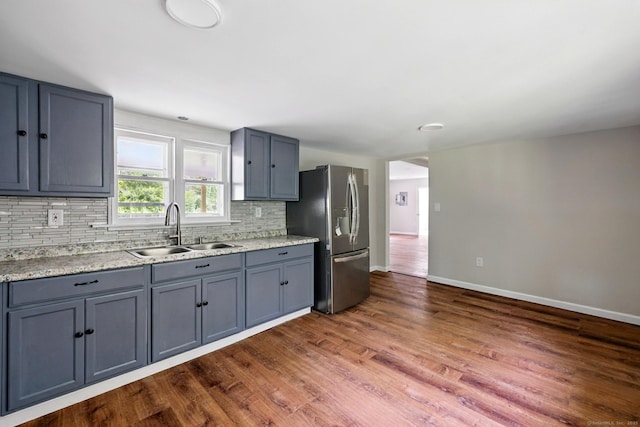 971 New Litchfield St, Torrington, CT 06790 - kitchen with stainless steel fridge, tasteful backsplash, dark wood-style flooring, and gray cabinetry
