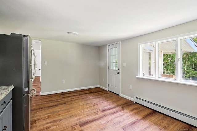 971 New Litchfield St, Torrington, CT 06790 - entryway featuring baseboard heating, wood finished floors, and healthy amount of natural light