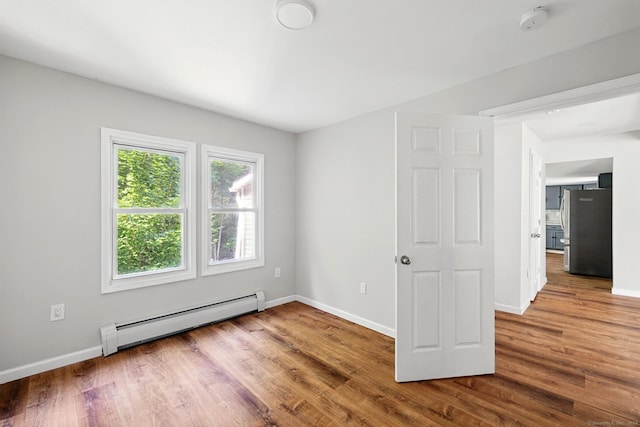 971 New Litchfield St, Torrington, CT 06790 - unfurnished room with baseboard heating, wood finished floors, and a smoke detector
