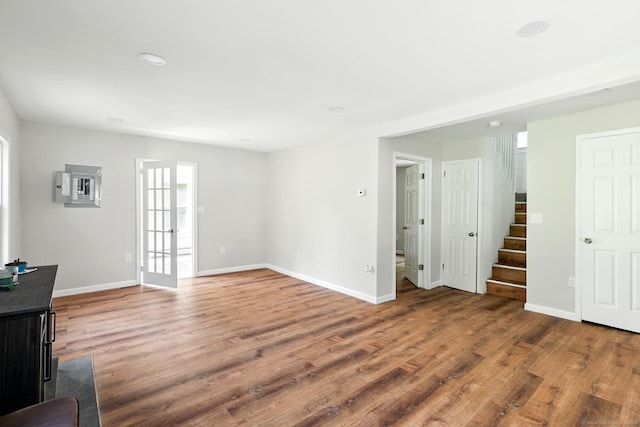 971 New Litchfield St, Torrington, CT 06790 - unfurnished living room with wood finished floors, stairway, french doors, electric panel, and recessed lighting