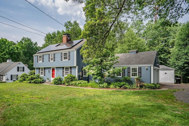 251 Ridgewood Rd, West Hartford, CT 06107 - colonial home with a chimney, solar panels, and a front lawn