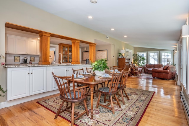 251 Ridgewood Rd, West Hartford, CT 06107 - dining area with light wood finished floors, ornate columns, lofted ceiling, recessed lighting, and baseboard heating