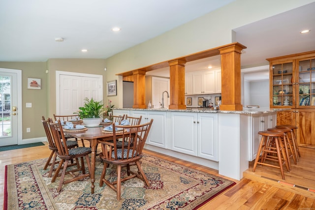 251 Ridgewood Rd, West Hartford, CT 06107 - dining space with light wood-style floors, recessed lighting, and decorative columns