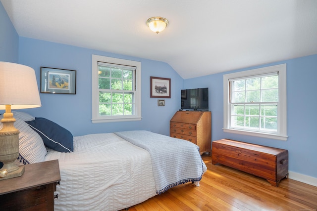 251 Ridgewood Rd, West Hartford, CT 06107 - bedroom featuring wood finished floors, vaulted ceiling, and multiple windows