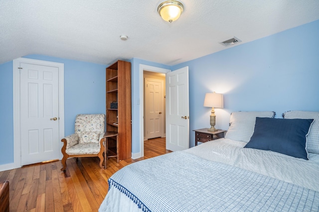 251 Ridgewood Rd, West Hartford, CT 06107 - bedroom with hardwood / wood-style flooring, a textured ceiling, and vaulted ceiling