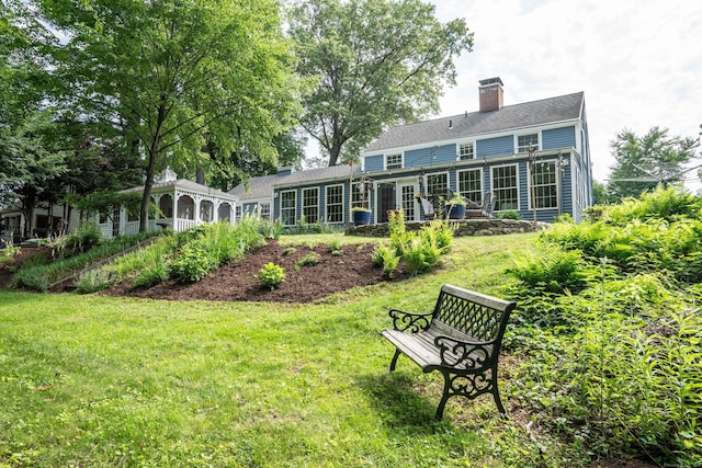 251 Ridgewood Rd, West Hartford, CT 06107 - rear view of house with a chimney and a yard