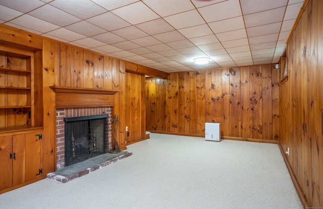 251 Ridgewood Rd, West Hartford, CT 06107 - unfurnished living room featuring carpet flooring, wood walls, a brick fireplace, and built in shelves
