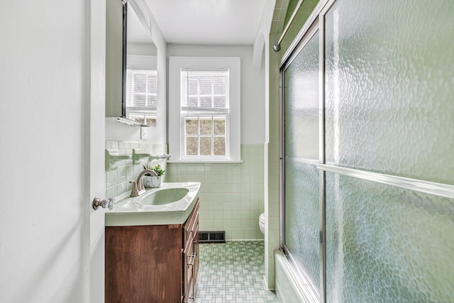 3 Wheeler Dr, Trumbull, CT 06611 - full bath with vanity, tile walls, a wainscoted wall, and shower / bath combination with glass door