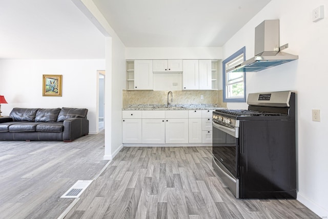 47 Manwaring Rd, Norwich, CT 06360 - kitchen featuring stainless steel range with gas stovetop, open shelves, exhaust hood, and light wood-style floors