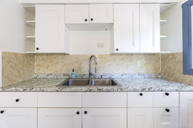 47 Manwaring Rd, Norwich, CT 06360 - kitchen with open shelves, white cabinets, tasteful backsplash, and light stone countertops