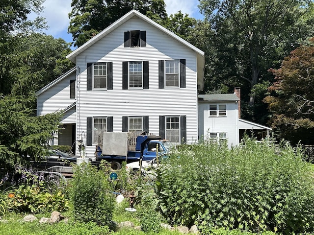 92 W Bridge St, Deep River, CT 06417 - view of front of property featuring a chimney and view of wooded area