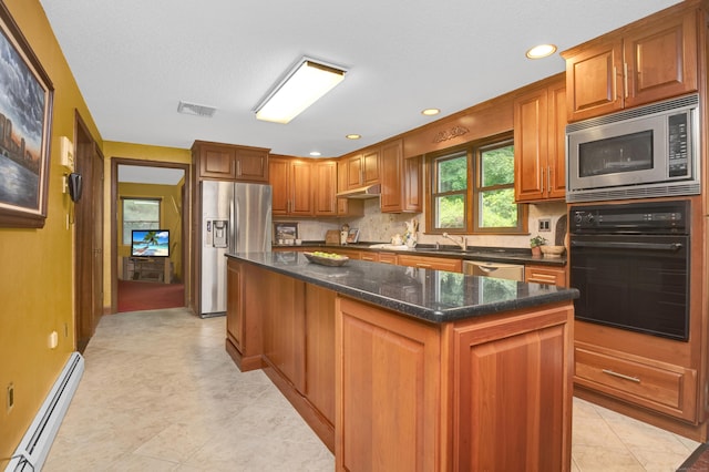 116 Bellridge Rd, Glastonbury, CT 06033 - kitchen featuring stainless steel appliances, a baseboard radiator, a kitchen island, under cabinet range hood, and tasteful backsplash