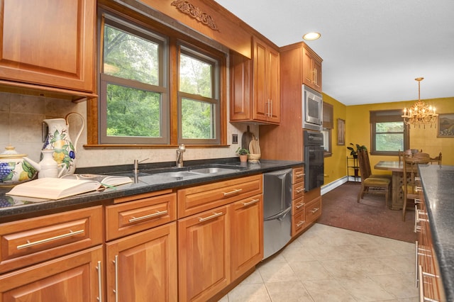 116 Bellridge Rd, Glastonbury, CT 06033 - kitchen featuring appliances with stainless steel finishes, brown cabinetry, light tile patterned flooring, a chandelier, and light carpet