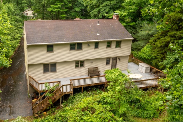 116 Bellridge Rd, Glastonbury, CT 06033 - rear view of house featuring a chimney, a wooden deck, and stairs