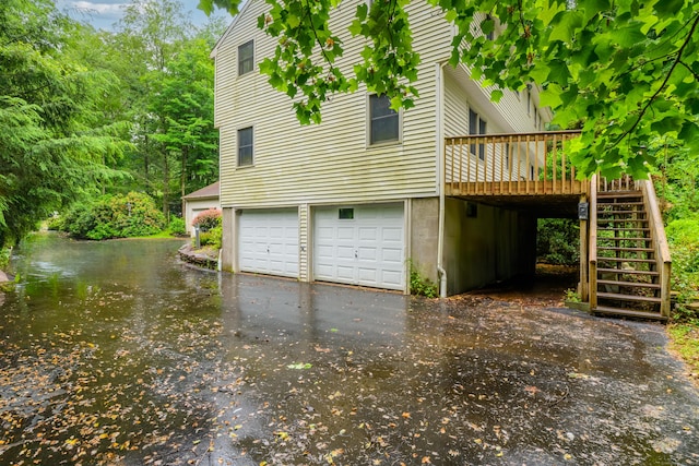 116 Bellridge Rd, Glastonbury, CT 06033 - view of property exterior with stairs, a deck with water view, an attached garage, and driveway