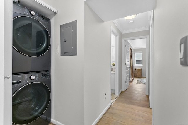 116 Southport Woods Dr, Fairfield, CT 06890 - washroom with estacked washer and dryer, electric panel, crown molding, and light wood-style floors