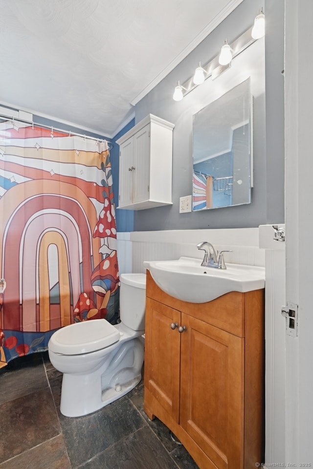 20 George St, Bristol, CT 06010 - bathroom featuring vanity, stone finish floors, a wainscoted wall, ornamental molding, and curtained shower