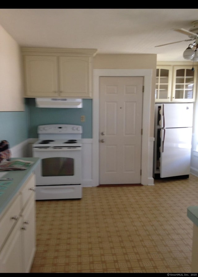 20 George St, Bristol, CT 06010 - kitchen featuring white appliances, under cabinet range hood, ceiling fan, light countertops, and white cabinetry