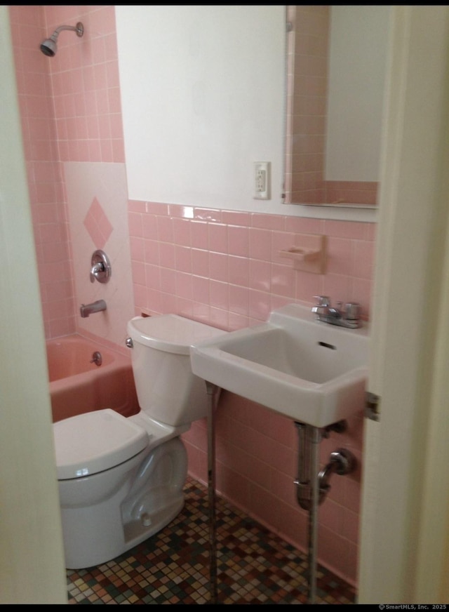 20 George St, Bristol, CT 06010 - full bathroom featuring tile walls, bathtub / shower combination, pet washing station, wainscoting, and tile patterned flooring