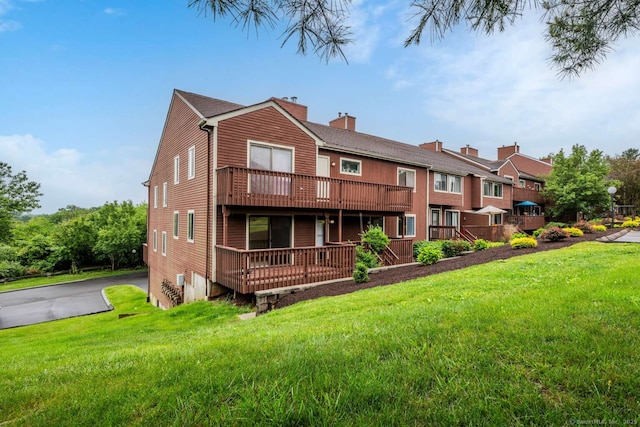 25 Florence Rd Unit 84, Branford, CT 06405 - view of front of property featuring a front lawn, a chimney, and driveway