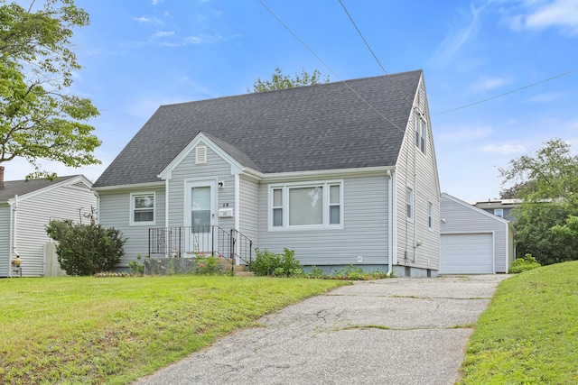 97 Travis Dr, Bridgeport, CT 06606 - cape cod home featuring a front yard, an outbuilding, roof with shingles, and a garage