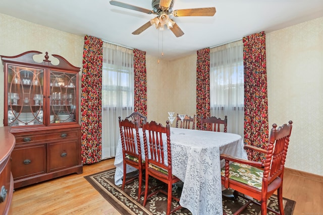 97 Travis Dr, Bridgeport, CT 06606 - dining area with wallpapered walls, light wood-style flooring, and a ceiling fan