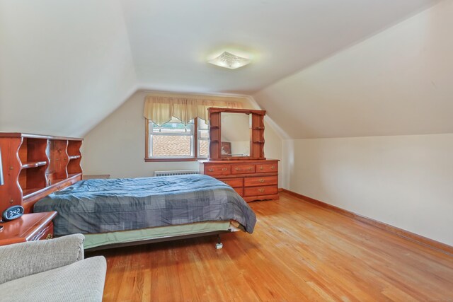 97 Travis Dr, Bridgeport, CT 06606 - bedroom featuring radiator heating unit, light wood finished floors, and lofted ceiling