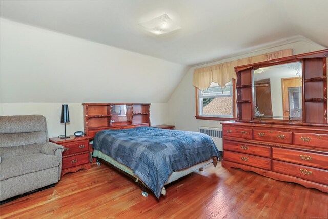 97 Travis Dr, Bridgeport, CT 06606 - bedroom with radiator heating unit, vaulted ceiling, and wood finished floors