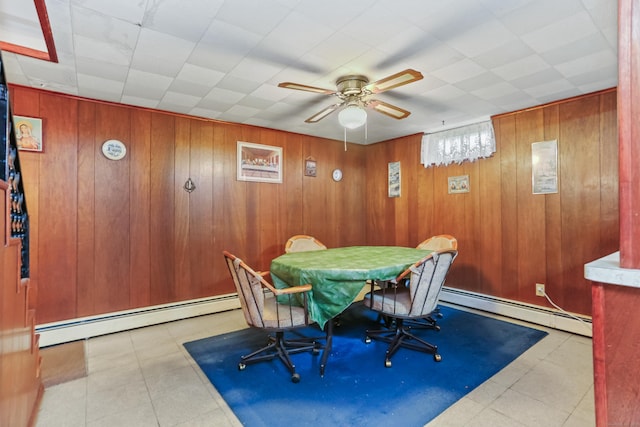 97 Travis Dr, Bridgeport, CT 06606 - dining area featuring baseboard heating, wood walls, and ceiling fan