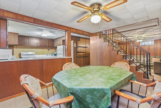 97 Travis Dr, Bridgeport, CT 06606 - dining space featuring a ceiling fan, billiards table, wood walls, and stairs