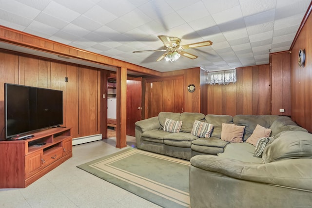 97 Travis Dr, Bridgeport, CT 06606 - living area with baseboard heating, wooden walls, light flooring, and a ceiling fan