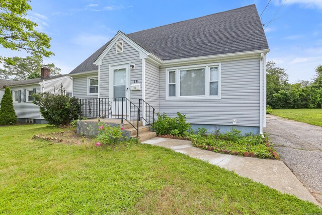 97 Travis Dr, Bridgeport, CT 06606 - view of front of home with a front yard and roof with shingles