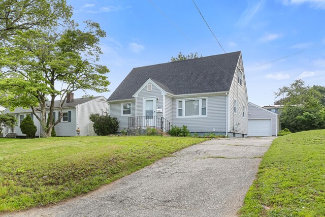 97 Travis Dr, Bridgeport, CT 06606 - new england style home featuring a shingled roof, a front lawn, and a detached garage
