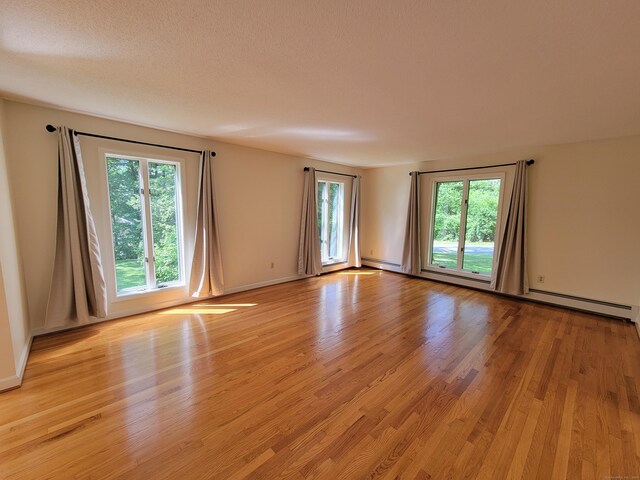 12 Enrico Rd, Bolton, CT 06043 - unfurnished room featuring light wood finished floors and baseboard heating