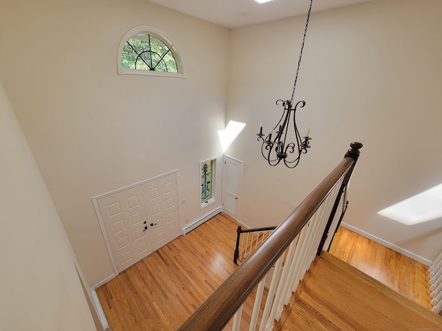 12 Enrico Rd, Bolton, CT 06043 - stairway with wood finished floors, a chandelier, and a towering ceiling